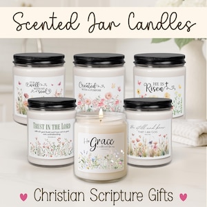 May include: Five glass jar candles with black lids, each featuring a white label with floral illustrations and religious text including It Is Well With My Soul, Created With A Purpose, He Is Risen, Trust In The Lord, and His Grace Is Sufficient For Me.