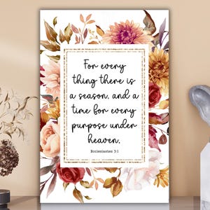 May include: A floral print art print with a gold border and the text "For every thing there is a season, and a time for every purpose under heaven." Ecclesiastes 3:1. The print features watercolor flowers in shades of pink, orange, and burgundy.