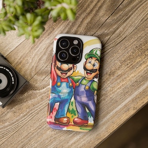 May include: A phone case featuring a colorful illustration of Mario and Luigi, the iconic video game characters. Mario is in a red shirt and blue overalls, while Luigi wears green and purple. The case has a white background with colorful accents.