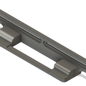 May include: A gray, rectangular, 3D-printed object with a slot and two curved supports. The object has a long, thin rectangular section with two parallel slots. The supports are on the bottom and have a curved design.