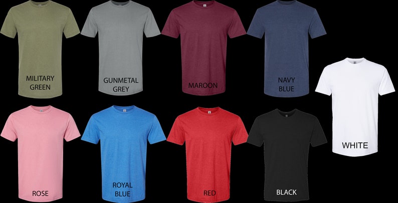 May include: A set of ten t-shirts in various colors, including military green, gunmetal grey, maroon, navy blue, white, rose, royal blue, red, black, and heather grey. The t-shirts are all crew neck and short-sleeved.