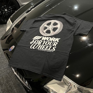 May include: Black t-shirt with a white graphic of a silver car wheel and the text "WORK FOR YOUR WHEELS".