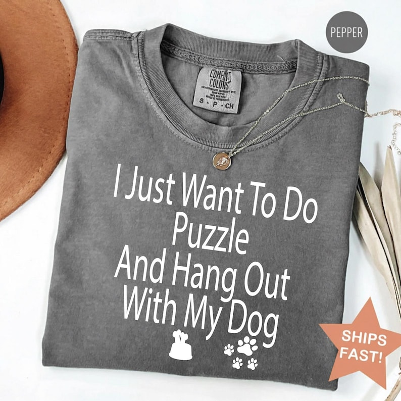 A pink t shirt that say, sorry i'm late i was doing a jigsaw