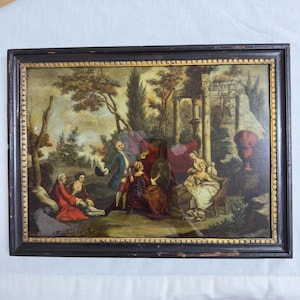 May include: A rectangular framed print depicting an 18th-century outdoor scene with five figures in period clothing. The group includes individuals in red, blue, and white garments gathered near stone ruins, trees, and a large urn under a sky.