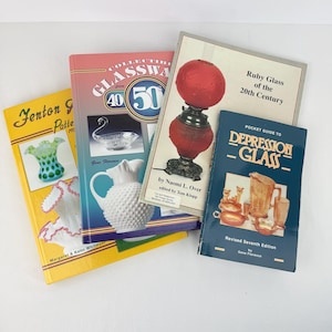 May include: A collection of four reference books about glassware. The books feature titles including Fenton Glass Patterns, Collectible Glassware from the 40s and 50s, Ruby Glass of the 20th Century, and a Pocket Guide to Depression Glass with cover images.