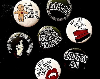 May include: A collection of seven round buttons with various designs and text. The buttons feature phrases like "Kill All Your Friends," "Dead!," "We All Go To Hell," and "Carry On." The color scheme includes black, white, and red, with some buttons displaying illustrations.