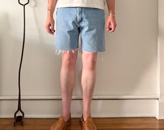 Medium wash Wrangler relaxed fit raw hem cutoff jean shorts ~ 33" waist