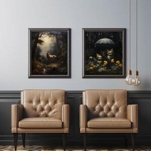 May include: Two framed paintings hanging on a wall above two brown leather armchairs. The painting on the left depicts a deer in a forest setting. The painting on the right depicts three small animals under an umbrella in a forest setting.