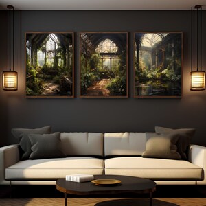 May include: Three framed prints of a overgrown greenhouse with lush greenery, sunlight streaming through the glass roof and windows. The prints are arranged in a row on a dark gray wall above a white couch.