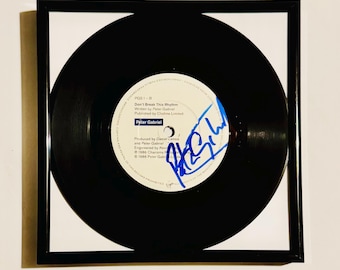 Disco de vinil autografado por Peter Gabriel, com certificado de autenticidade e moldura.