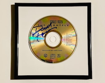 CD autografado por Donald Fagen com certificado de autenticidade e moldura.