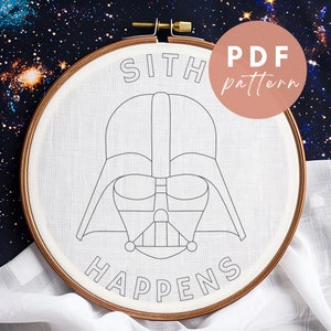 May include: A white embroidery hoop with a black line drawing of Darth Vader's helmet. The text "SITH HAPPENS" is written above and below the helmet. The text "PDF pattern" is written in a pink circle in the upper right corner of the image.