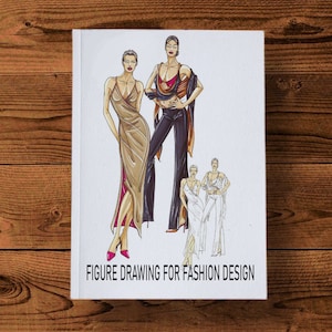 以下が含まれることがあります： 「Figure Drawing for Fashion Design」というタイトルの書籍の表紙。表紙には、異なる服装をした女性を描いたファッションイラストが3つあります。イラストはカラフルなスタイルで描かれています。