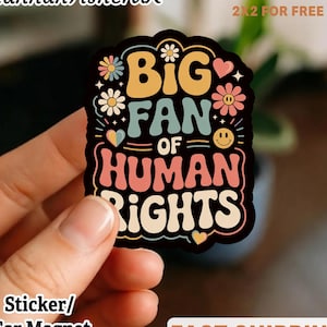 May include: A vibrant sticker with the phrase "BIG FAN OF HUMAN RIGHTS" in a retro style. The design incorporates floral and heart motifs in yellow, pink, and blue. The words "Sticker/Car Magnet" are also visible.