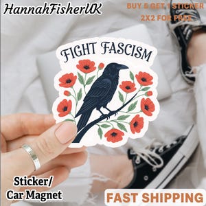 Puede incluir: Una pegatina o imán para coche con un cuervo negro posado en una rama, rodeado de amapolas rojas. El texto "FIGHT FASCISM" está arriba. El vendedor es "HannahFisherUK".