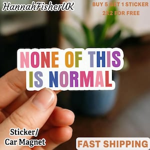 May include: A colorful sticker with the text "NONE OF THIS IS NORMAL" in various colors. The sticker is held by a hand. The words "Sticker/Car Magnet" are at the bottom. The seller's name "HannahFisherUK" is at the top left.