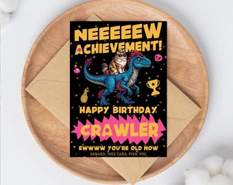 May include: A birthday card with a black background featuring a blue dinosaur with a cat on its back. The card reads "NEEEEEW ACHIEVEMENT! HAPPY BIRTHDAY CRAWLER EWWWW YOU'RE OLD NOW REWARD. THIS CARD, FUCK YOU."