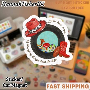 May include: A die-cut sticker featuring a black tire frame surrounding a scene with cartoon characters, a red cowboy hat, a red cowboy boot with the name Taylor, and the text Love has ways of bringing things back to life in brown script.