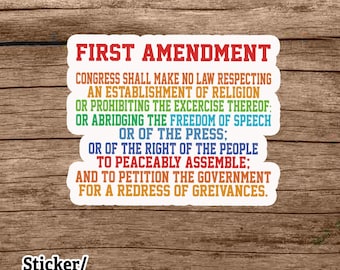 May include: A white sticker or car magnet featuring the text "FIRST AMENDMENT" in red. The First Amendment text is printed below in various colours. The words "Sticker/Car Magnet" are at the bottom.