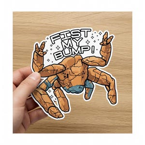 May include: A sticker featuring a cartoonish, rock-like creature with raised arms and the text "FIST MY BUMP!". The creature is primarily brown with blue accents, and the text is in a bold, outlined font with star accents.