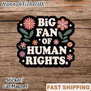 May include: Black sticker with the text "BIG FAN OF HUMAN RIGHTS" in white, surrounded by floral designs in pink, orange, and purple. The sticker also says "Sticker/Car Magnet".