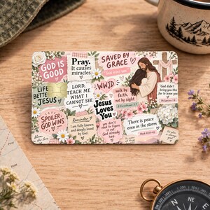 May include: A rectangular credit card skin featuring a collage of floral patterns and religious text including phrases like God is Good, Saved by Grace, and Jesus Loves You, with an illustration of a person embracing a figure representing Jesus.