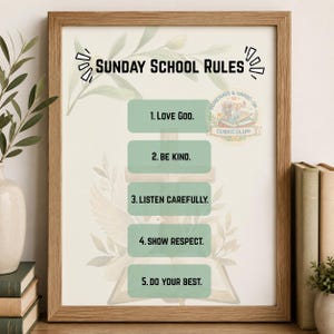 May include: A framed wall art print titled Sunday School Rules with five numbered points: 1. Love God, 2. Be Kind, 3. Listen Carefully, 4. Show Respect, 5. Do Your Best. The design features a cross, an open book, and green leaves on a white background.