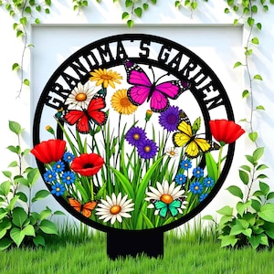 May include: A black metal garden sign with the text "Grandma's Garden" in a circle. The sign is decorated with colorful flowers and butterflies.