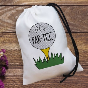 May include: White drawstring bag with a golf ball design and the text "Let's Par-Tee".