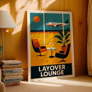 May include: A framed art print featuring a retro-style illustration of an airport layover lounge. The artwork depicts an airplane, orange sun, two chairs, a table with a drink, and a plant. The words "LAYOVER LOUNGE" are at the bottom.