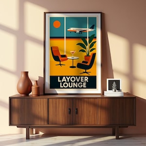 May include: A framed art print with a retro travel theme. The artwork depicts a lounge scene with an airplane, chairs, and the text "LAYOVER LOUNGE". The print is displayed on a wooden cabinet with vases and a small framed picture.