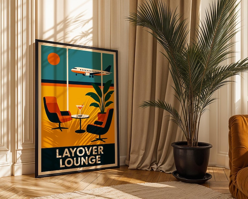 May include: A framed art print with a retro travel theme. The artwork depicts a stylized airport lounge scene with an airplane, chairs, and a cocktail. The words "LAYOVER LOUNGE" are at the bottom. The print is displayed in a room with a large potted plant.