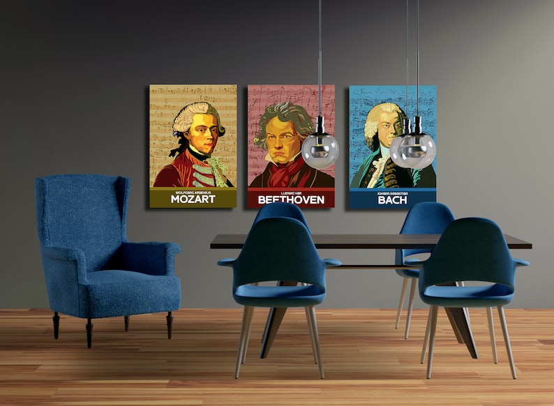 May include: Three framed posters of famous composers, Mozart, Beethoven, and Bach, hanging on a gray wall above a dark wood dining table with blue chairs.