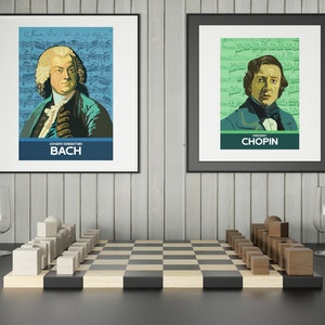 May include: Two framed posters of famous composers, Johann Sebastian Bach and Frederic Chopin, with their portraits against a background of musical notes. A wooden chessboard with white and brown pieces is in the foreground.