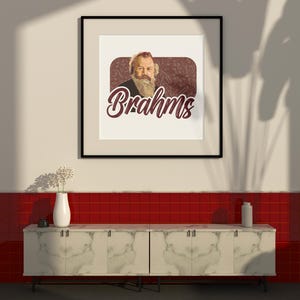 K&ouml;nnte beinhalten: Ein schwarzer gerahmter Druck mit wei&szlig;em Hintergrund, der ein Portr&auml;t von Johannes Brahms, einem deutschen Komponisten, mit dem Wort "Brahms" in einer stilisierten Schrift unter dem Portr&auml;t zeigt. Der Druck h&auml;ngt an einer wei&szlig;en Wand &uuml;ber einer wei&szlig;en Marmor-Arbeitsplatte mit roten Fliesen dahinter.