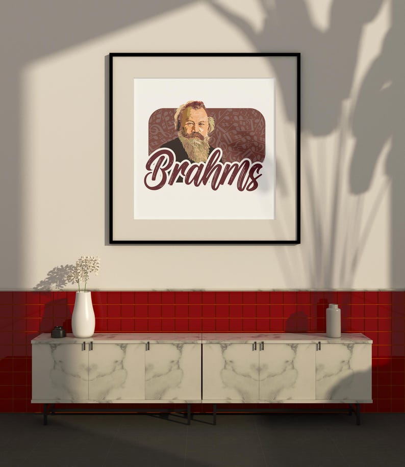 K&ouml;nnte beinhalten: Ein schwarzer gerahmter Druck mit wei&szlig;em Hintergrund, der ein Portr&auml;t von Johannes Brahms, einem deutschen Komponisten, mit dem Wort "Brahms" in einer stilisierten Schrift unter dem Portr&auml;t zeigt. Der Druck h&auml;ngt an einer wei&szlig;en Wand &uuml;ber einer wei&szlig;en Marmor-Arbeitsplatte mit roten Fliesen dahinter.