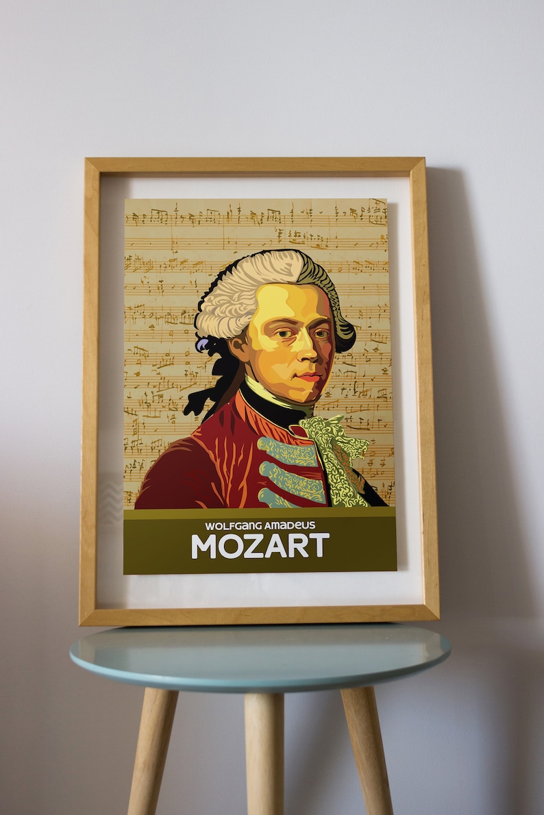 May include: A framed poster featuring a portrait of Wolfgang Amadeus Mozart. The poster has a yellow background with musical notes and a gold border. The text "WOLFGANG AMADEUS MOZART" is printed in black at the bottom of the poster.