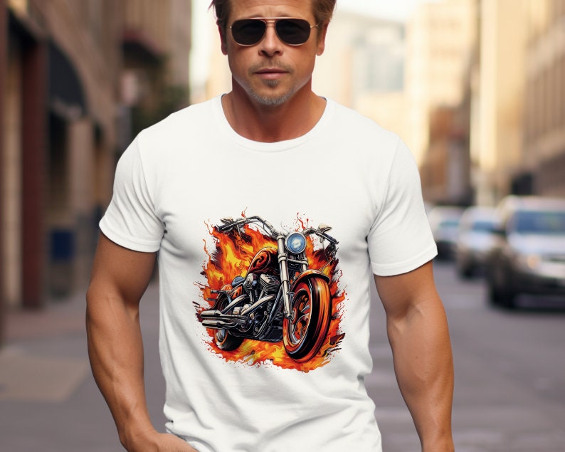 May include: White t-shirt with a graphic of a motorcycle engulfed in flames.