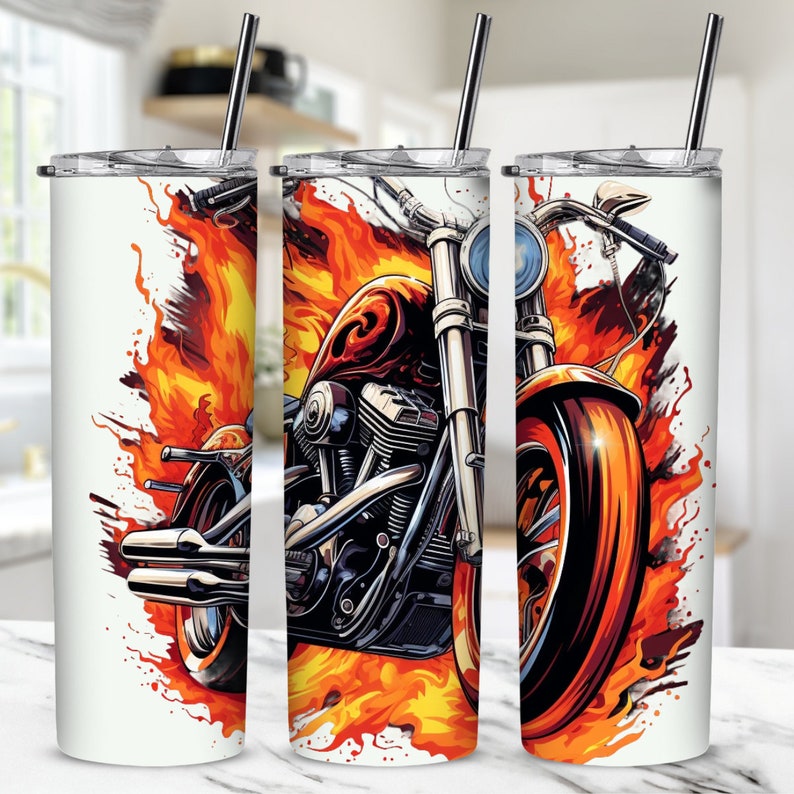 May include: A stainless steel tumbler with a design of a motorcycle engulfed in flames. The motorcycle is silver and red with a black seat. The flames are orange and yellow.