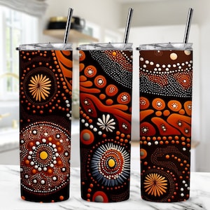 May include: Three stainless steel tumblers with lids and straws. Each tumbler features a different design of orange, brown, and white abstract dot art.