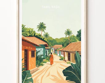 May include: Framed art print depicting a street scene in Tamil Nadu, India. The illustration features colorful buildings with orange and green facades, palm trees, and a person in orange robes walking down a sandy path. The text "TAMIL NADU" is at the top.