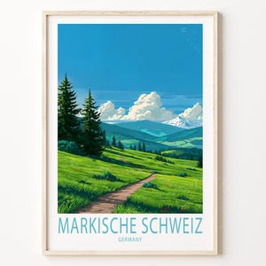 May include: Framed art print of a scenic landscape with a path winding through a green meadow. The artwork features a bright blue sky, fluffy white clouds, and distant mountains. The text "MARKISCHE SCHWEIZ GERMANY" is printed at the bottom.