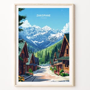 May include: A framed art print featuring a scenic view of Zakopane, Poland. The artwork depicts wooden cabins lining a street, with a backdrop of snow-capped mountains and a clear blue sky. The print includes the text "ZAKOPANE" at the top.