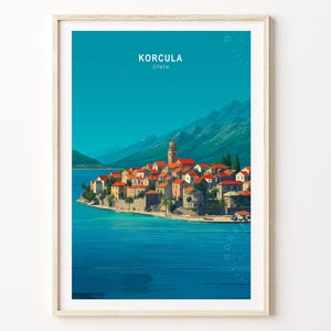 May include: A framed art print of Korcula, Spain. The artwork depicts a coastal town with red-tiled roofs, stone buildings, and a tall bell tower, set against a turquoise sea and a backdrop of mountains under a clear blue sky.