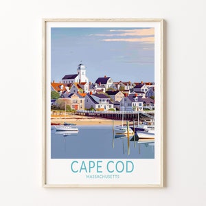May include: A framed art print featuring a coastal town scene with a white lighthouse, colorful houses, and boats in the harbor. The words "CAPE COD MASSACHUSETTS" are printed at the bottom in teal.