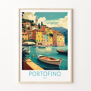 May include: A vintage travel poster featuring a colorful illustration of the Italian town of Portofino. The poster depicts a picturesque harbor with boats and a charming village nestled on a hillside.