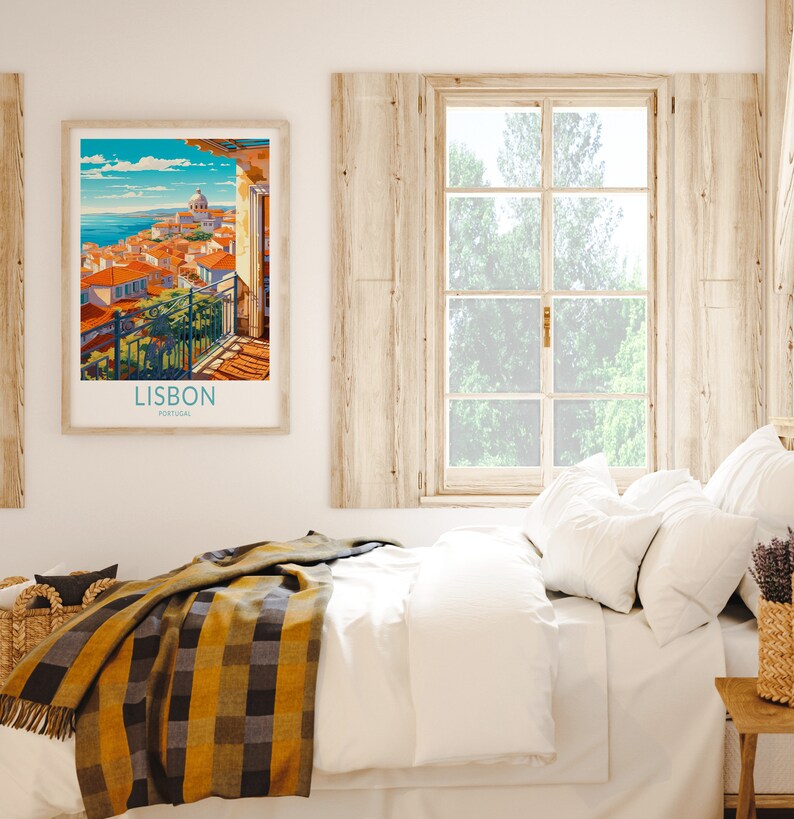 May include: A framed vintage travel poster with a colorful illustration of Lisbon, Portugal. The poster features a cityscape with buildings, a church, and a blue sky with white clouds. The text "LISBON PORTUGAL" is printed at the bottom of the poster.