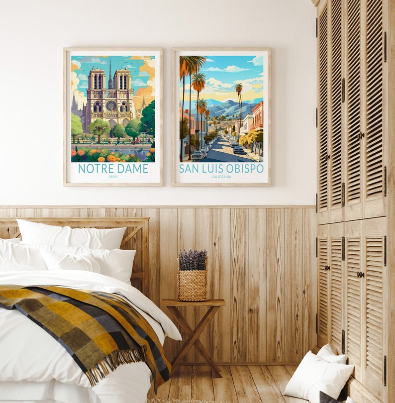 May include: Two framed travel posters, one featuring Notre Dame Cathedral in Paris, France, and the other featuring a street scene in San Luis Obispo, California.