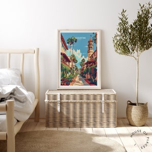 May include: A colorful illustration of a street scene in St. Augustine, Florida. The image features a tall tower with a clock, palm trees, and colorful buildings. The text "St. Augustine, Florida" is printed at the top of the image.
