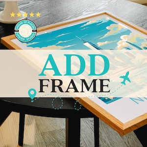 May include: A framed print of a city skyline with a blue sky and white clouds. The print is on a wooden table with a black surface. The text "ADD FRAME" is in the foreground of the image.